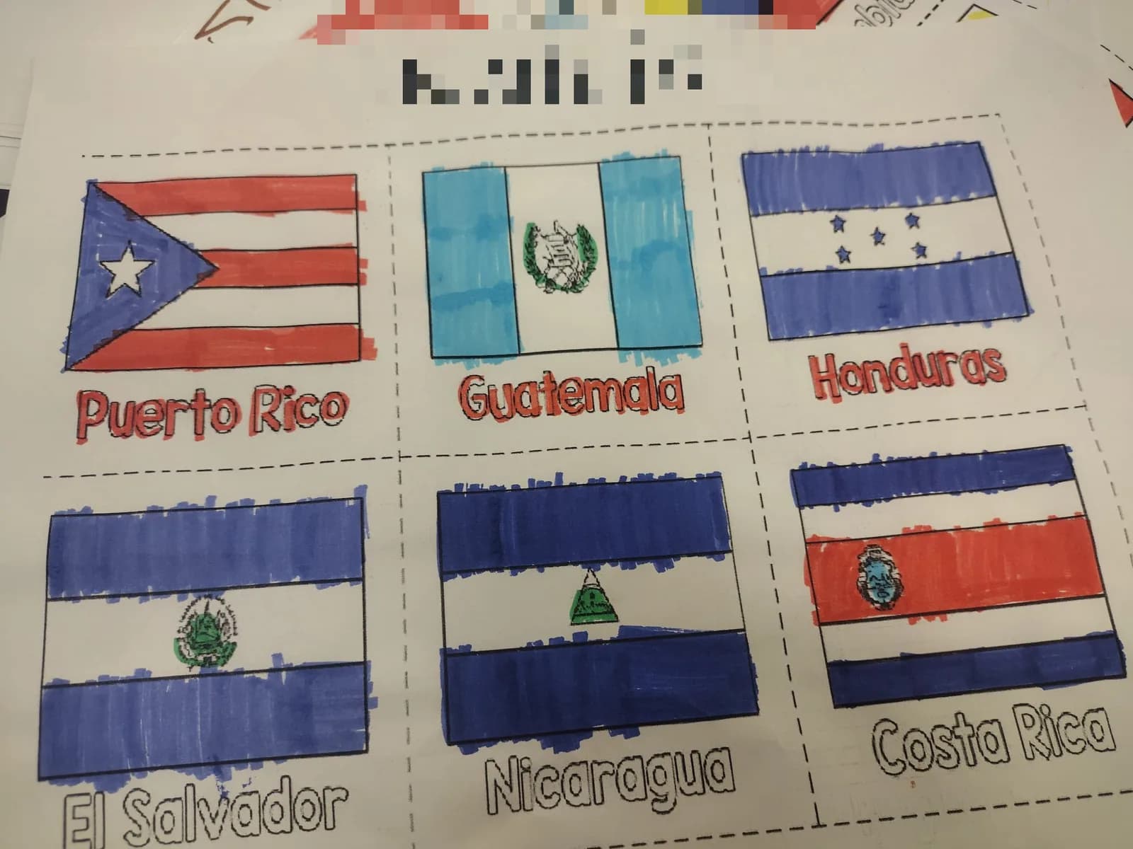 A worksheet with the flags of Puerto Rico, Guatemala, Honduras, El Salvador, Nicaragua and Costa Rica, coloured in marker