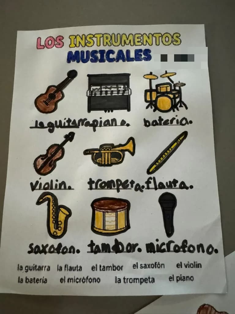 A worksheet of musical instruments coloured in black and gold with the Spanish words written underneath